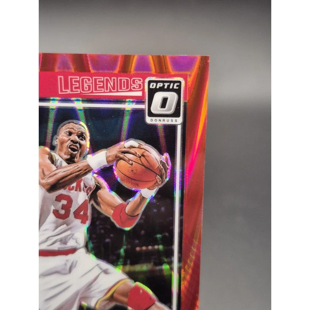 2024-25 Panini Optic Hakeem Olajuwon #249 Legends Red Seismic Prizm /149 Rockets
